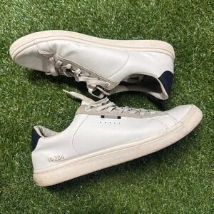White and‎ navy leather sneakers with a minimalist design, featuring a comfort